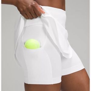 Lululemon Brand new,tags on white, asymmetrical tennis skirt, size 10